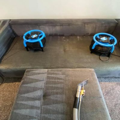 Clean sectional sofa cushions stacked, showing the dry, refreshed, and uniform appearance of the fabric after professional cleaning and drying.