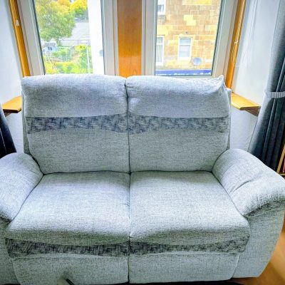 After deep cleaning the sectional sofa, showcasing the immediate visual improvement, fluffier texture, and refreshed light fabric.