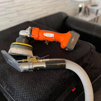 Overview of carpet deep cleaning in a hallway or common area, showcasing the use of specialized rotational tools for maximum dirt agitation and lift.