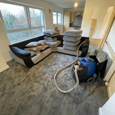 Detailed close-up of area rug cleaning with commercial-grade spot-treating equipment to remove tough stains and revitalize the fibers.