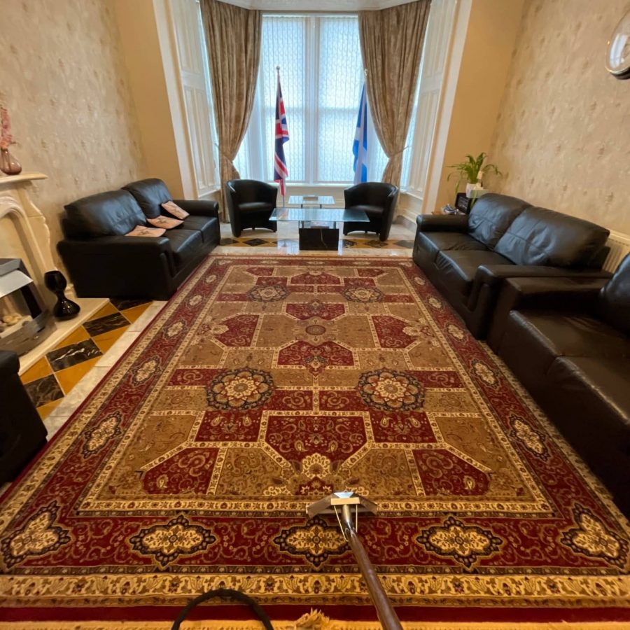 Professional carpet and rug cleaning equipment set up on site.